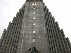 02A Looking up at the entrance facade of Hallgrimskirkja Church to the clock and observation platform Reykjavik Iceland