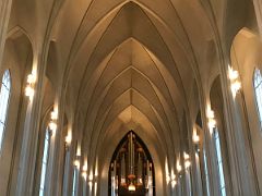 04B Looking up the towering nave to the large pipe organ over the entrance door from the main altar of Hallgrimskirkja Church Reykjavik Iceland