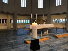 06A The stark and plain altar with curved windows behind in Hallgrimskirkja Church Reykjavik Iceland