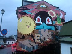 06A Mural with colourful quirky characters including the sun by visual artists, Dabs Myla, with Kems Street Art Reykjavik Iceland