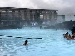 02B After changing you leave the building, hang up your white robe and enter the hot blue refreshing water Blue Lagoon geothermal spa Iceland
