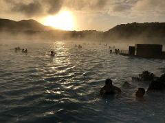 03B Steam rises from the hot blue refreshing water highlighted by the low sun Blue Lagoon geothermal spa Iceland