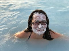 03C Charlotte Ryan wears a natural white clay silica mask in the hot refreshing water in Blue Lagoon geothermal spa Iceland