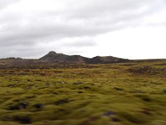 01A We drove south on road 42 from Reykjavik with green moss covered lava and mountains Reykjanes Peninsula Iceland