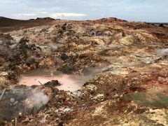 10A Colourful red, green and yellow deposits with hot steam fumaroles at Gunnuhver geothermal area Reykjanes Peninsula Iceland