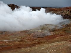 10D A huge hot steam fumarole blows over the colourful red and yellow ground at Gunnuhver geothermal area Reykjanes Peninsula Iceland