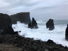 13B The ocean pounds the spiky rock formations created by volcanic eruptions with Valahnukur cliff Reykjanes Peninsula Iceland