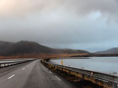 03B Driving on Road 54 across a causeway on Seljafjordur inlet with Klakkur mountain ahead driving to Grundarfjordur Snaefellsnes Peninsula Iceland