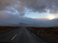 06B The sun breaks thru the clouds driving on road 574 with mountains ahead Snaefellsjokull National Park Snaefellsnes Peninsula Iceland