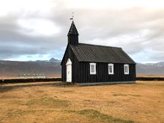 05A The black Budir Church is the oldest wooden church in Iceland built in 1703 by a Swedish merchant on Snaefellsnes Peninsula Iceland