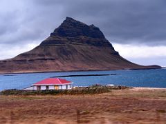 01B Hellnafell Guesthouse on the shore with Kirkjufell Church Mountain across the water driving on road 54 from Grundarfjordur Snaefellsnes Peninsula Iceland