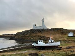 02A The beautiful modern white Stykkisholmskirkja church stands on a small hill overlooking the ocean coastline in Stykkisholmur on Snaefellsnes Peninsula Iceland