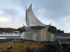 04A A Heimleid sculpture by Grimur Marino Steindorsonn 1994 is a sailboat made of stainless steel Stykkisholmur harbour Snaefellsnes Peninsula Iceland