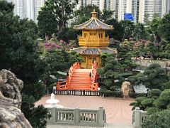 08B The golden Pavilion of Absolute Perfection building and manicured trees, rocks and water from the entrance to Nan Lian Garden Hong Kong