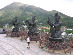 Hong Kong 01 09 Peter With Votive Figures and Po Lin Monastery Downhill Pete and Zig-zag admire the statues of votive servants making offerings to Buddha. You can try and toss some coins into their outstretched hands. The Po Lin...