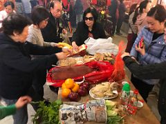 06C Offer table includes vegetables, a chicken, suckling pig, fruit, and buns at Man Mo Temple Hong Kong