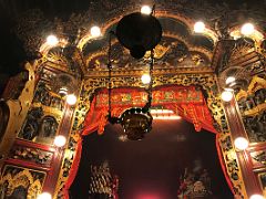 10C Decorate wooded frame with carved scenes surround Man and Mo Taoist statues at Man Mo Temple Hong Kong