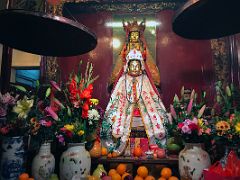 16B Two statues with flower and fruit offerings at Lit Shing Kung, part of Man Mo Temple Hong Kong