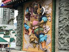 03A Guard Weituo menshen holds a giant axe and protects against evil influences at entrance to Wong Tai Sin temple Hong Kong