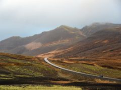 02A Road 54 snakes thru the green moss covered lava with Bjarnarhafnarfjall mountain driving to Grundarfjordur Snaefellsnes Peninsula Iceland