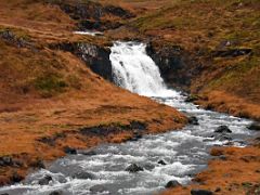 02A A small waterfall on the side of road 54 driving west near Grundarfjordur Snaefellsnes Peninsula Iceland