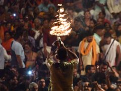 06B A Brahmin Holds A Multi-Tiered Fire Lamp In Front Of The People On The Ghat Steps At The Ganga Aarti Fire Ceremony On The Banks Of The Ganges Varanasi India