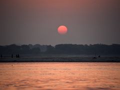 05B The Sun Glows Bright Red At Sunrise Over The Ganges River Varanasi India
