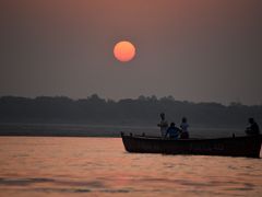 07A The Sun Glows Bright Red At Sunrise Over The Ganges River From A Tourist Boat In Varanasi India