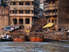 13A Wood Is Piled Up On Boats And The Steps Of The Manikarnika Burning Ghat After Sunrise From Tourist Boat On Ganges River Varanasi India
