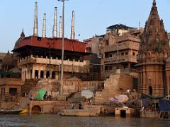 13B The Manikarnika Burning Ghat And Shiva Temple On Right After Sunrise From Tourist Boat On Ganges River Varanasi India