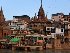 13C The Manikarnika Burning Ghat And Shiva Temple On Left After Sunrise From Tourist Boat On Ganges River Varanasi India