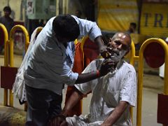 01A Getting An Early Morning Shave On The Crowded Street Of Varanasi Old Town India