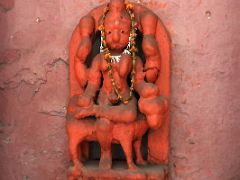 12A Orange Carved Hindu Figure At A Small Temple In Varanasi Old Town India
