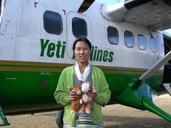 Kangchenjunga 10 04 Yeti Airlines Stewardess at Suketar Danger Dangles and the Zig-Zagger being held by a nice friendly young stewardess in front of Yeti Airlines at the airport in Suketar. Now, we thought that the…