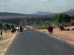 02C Driving Through A Small Village With Maasai And Animals On The Road On The Drive To Arusha Tanzania To Climb Mount Kilimanjaro