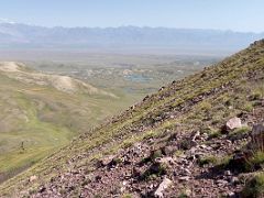 07A Green hills and the plain stretching to the hills on the horizon from the shoulder ridge of Pik Petrovski on day hike from Ak-Sai Travel Lenin Peak Base Camp 3600m