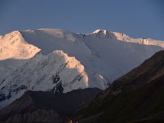 09D The light quickly changes from orange to white at sunrise on Lenin Peak from Ak-Sai Travel Lenin Peak Base Camp 3600m