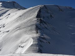 03C The beginning of the Lenin Peak summit ridge showing the zig zag trail to camp 4 to the left of centre from Ak-Sai Travel Lenin Peak Camp 3 6100m