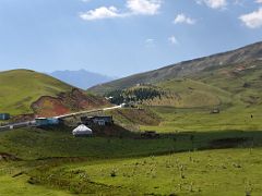 05A Yurts dot the green hills from the Pamir Highway as the road nears Chirchik Pass on the way to Lenin Peak Base Camp