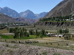 08B Fertile land and small villages hug the mountain scenery on the Pamir Highway between Chirchik Pass and Taldyk Pass on the way to Lenin Peak Base Camp