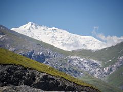 11B Lenin Peak poking above the surrounding hills on the Pamir Highway from Taldyk Pass 3615m on the way to Lenin Peak Base Camp