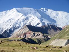 03D The green hills lead to the gorge with Lenin Peak white above on way from Base Camp 3600m to the beginning of the trek at 3800m toward Ak-Sai Travel Lenin Peak Camp 1 4400m