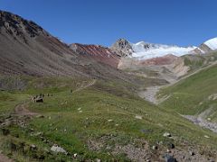 06C Wide U-shaped valley with Travellers Pass 4133m to the left of the red cliff and snow covered mountains beyond on the way to Ak-Sai Travel Lenin Peak Camp 1 4400m