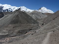 12 The trail descends to the river crossing 4220m with Razdelnaya Peak L, Peak of the 30th Anniversary of the USSR C, Yuhin Peak R on the way to Ak-Sai Travel Lenin Peak Camp 1 4400m