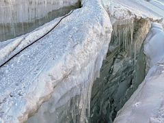 08A Crossing a narrow snow bridge with a deep crevasse on both sides on the way to Ak-Sai Travel Lenin Peak Camp 2 5400m