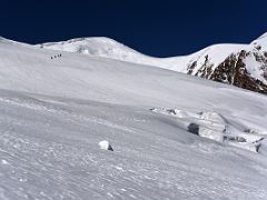 12A Climbers ascend the last sloping traverse before Lenin Peak camp 1 becomes visible on the way to Ak-Sai Travel Lenin Peak Camp 2 5400m