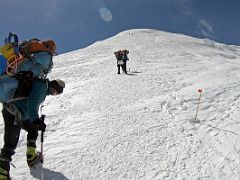 04B Resting briefly as we zig zap up the steep face of Razdelnaya Peak on the way to Ak-Sai Travel Lenin Peak Camp 3 6100m