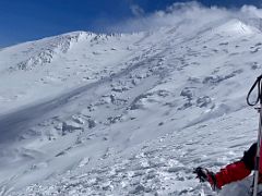 05B Resting with the summit ridge above on the steep face of Razdelnaya Peak on the way to Ak-Sai Travel Lenin Peak Camp 3 6100m