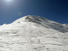 02A Looking up to the steep ascent to Lenin Peak camp 4 6430m from the col at 6020m