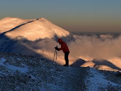 02B Taking a short break to admire sunrise on Dzerzhinsky Peak on the way to the Lenin Peak summit